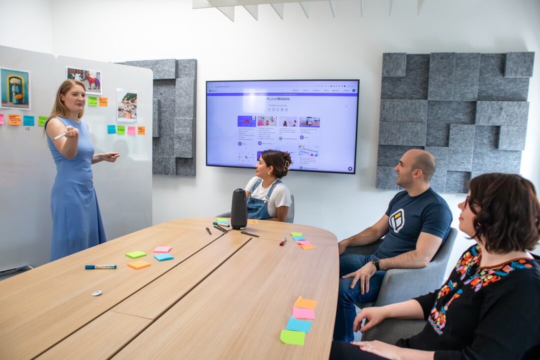 Business leader addressing a small team in a bright meeting room