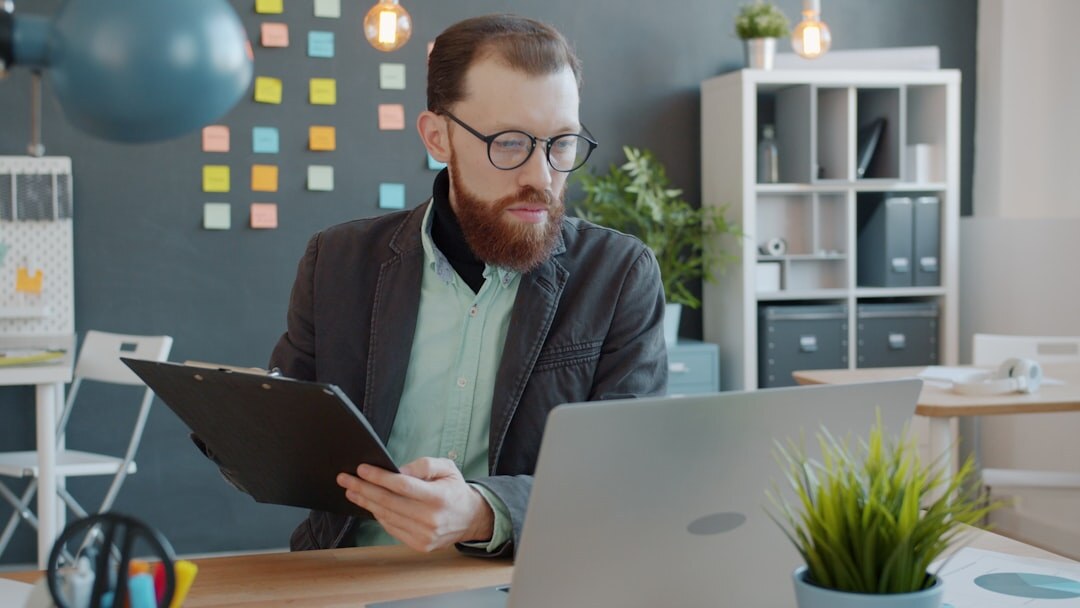Financial analyst reviewing charts and reports in a modern office